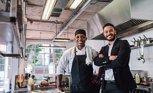 Restaurant owner with chef in kitchen